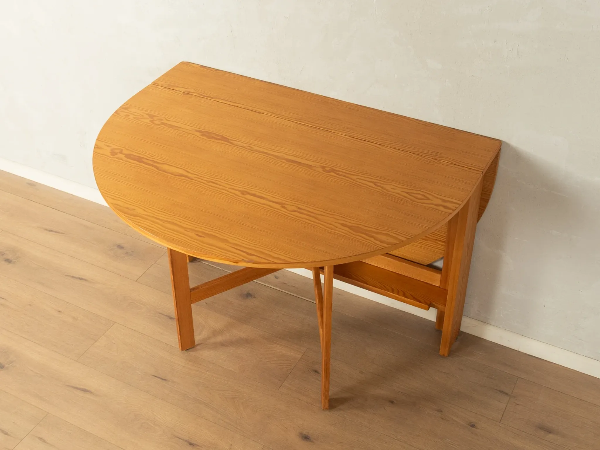 Practical folding table from the 1980s made of light brown pine wood