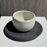 White Indonesian ceramic cup and gray saucer