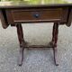 Small drop-leaf side table in English style with leather top & drawer.