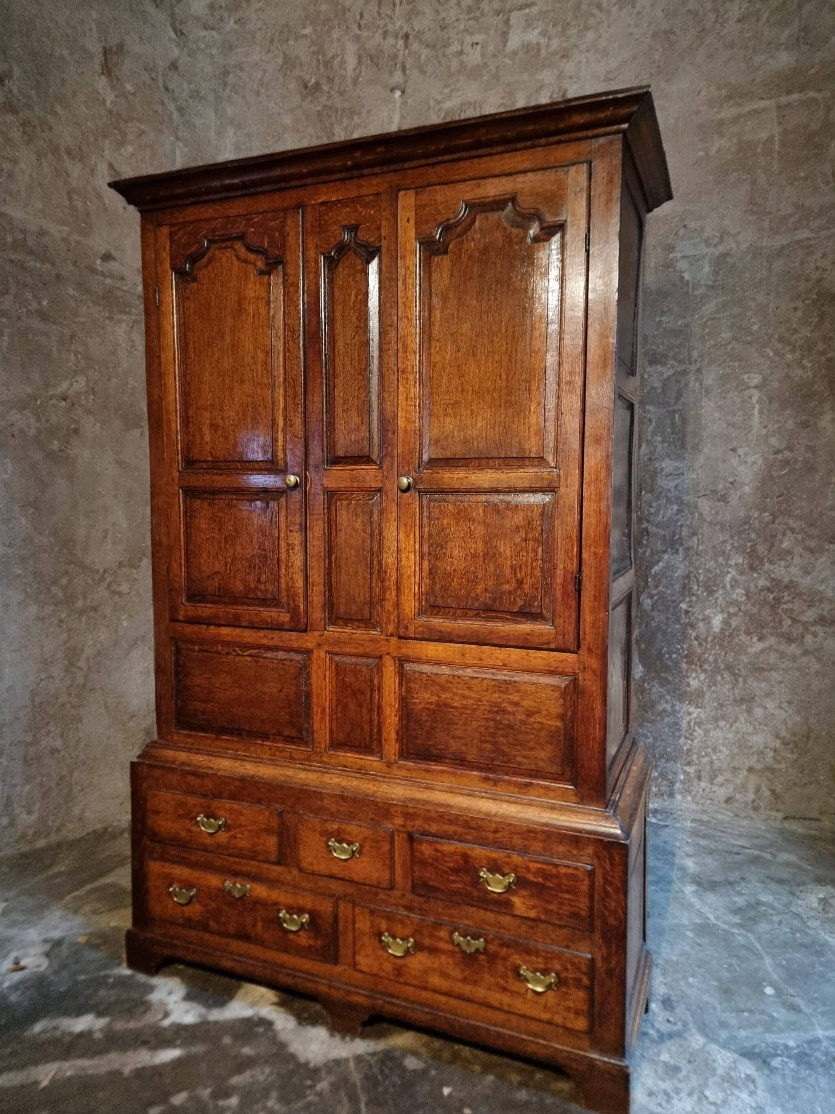 Antique English oak wardrobe with drawers, England, circa 1800–1820.