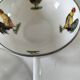 Cup and saucer in porcelain decorated with roosters and hens.