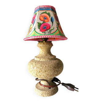 Sandstone foot accent lamp surmounted by a painted lampshade