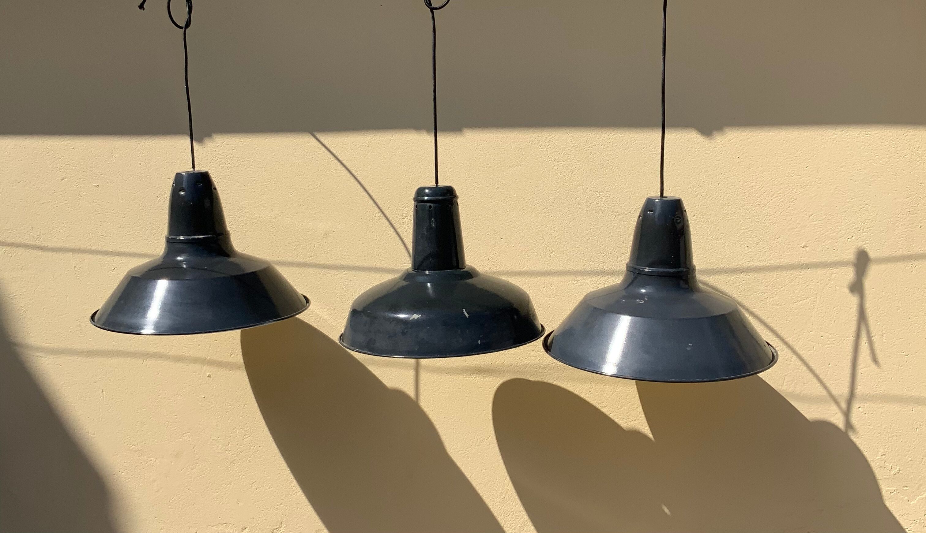 Three industrial suspensions in black and white enamelled sheet metal large format