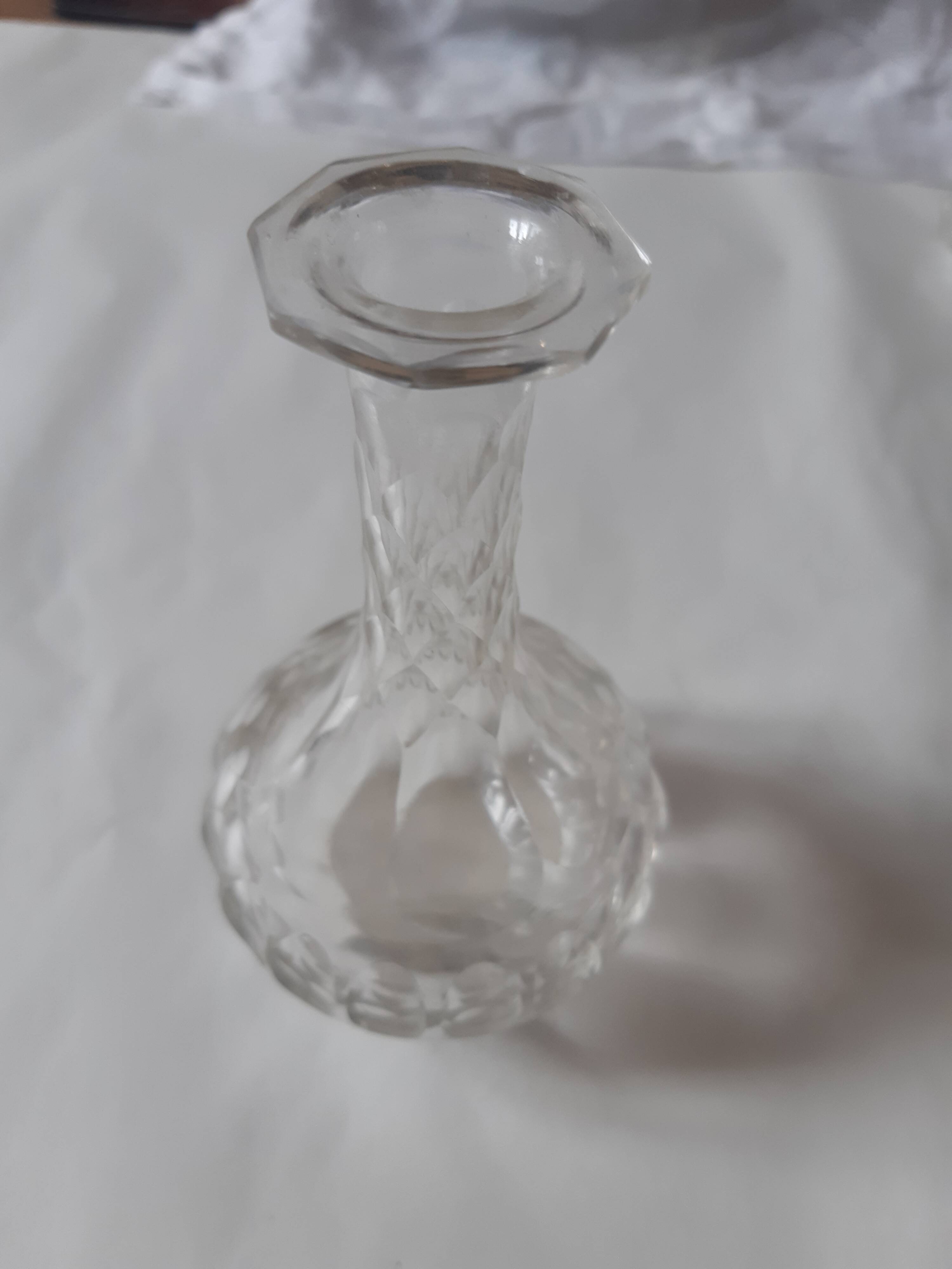 Cut crystal oil bottle with its crystal stopper.