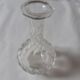 Cut crystal oil bottle with its crystal stopper.