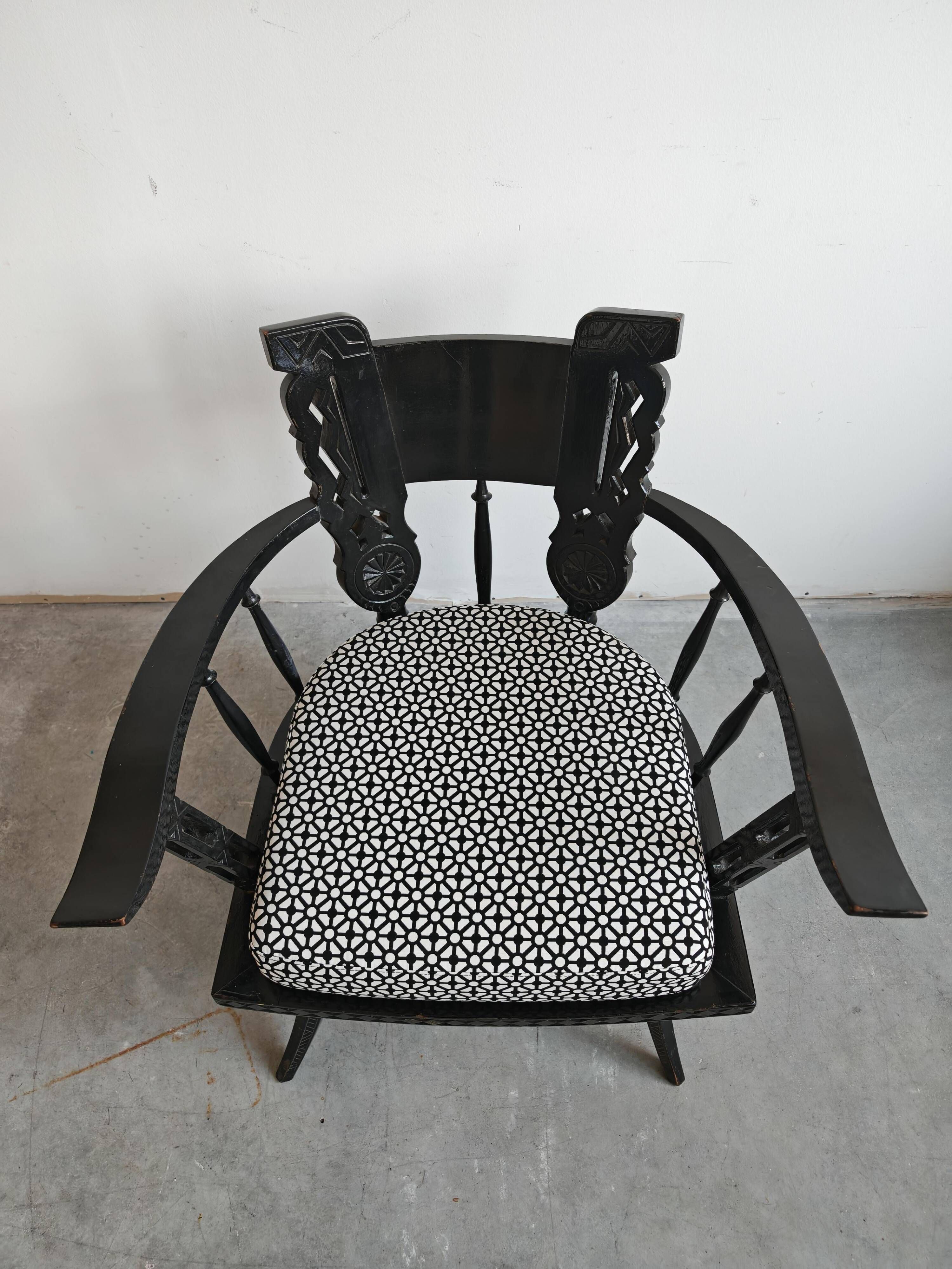 Pair of antique hand-carved armchairs in black lacquer from the 1920s.