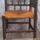 Fireplace corner chair in Louis XIII style, turned wood with braided rush, 19th century.