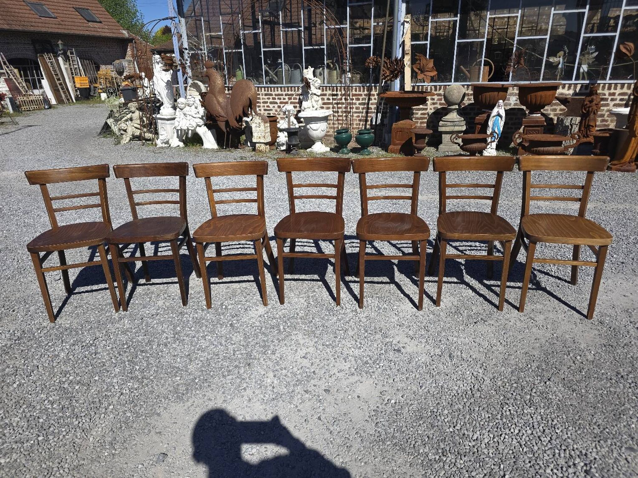 7 curved wooden bistro chairs by Baumann
