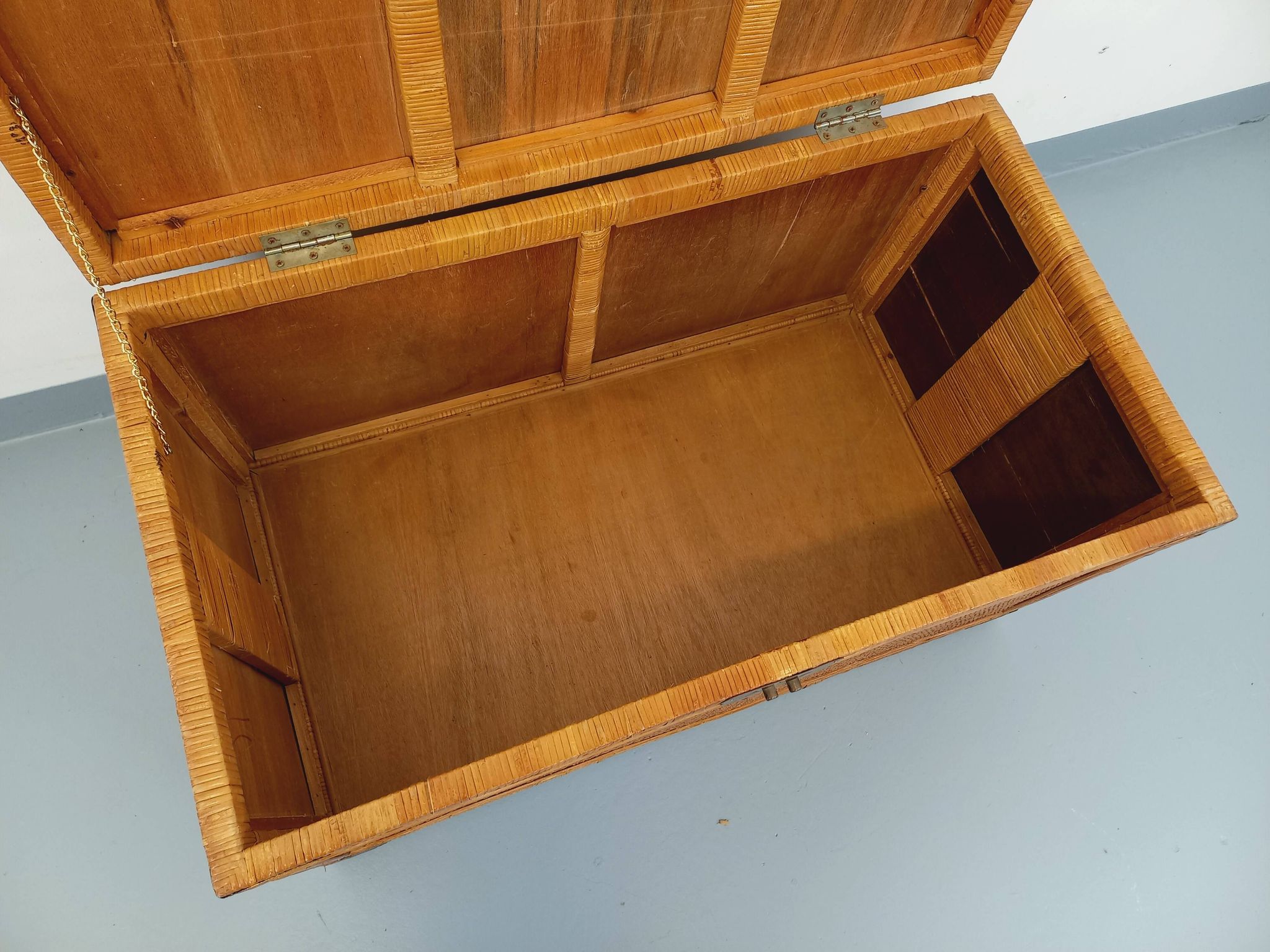 Vintage trunk in wood, rattan, caning, and brass.