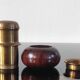 Vintage salt and pepper shaker duo in brass and turned wood.