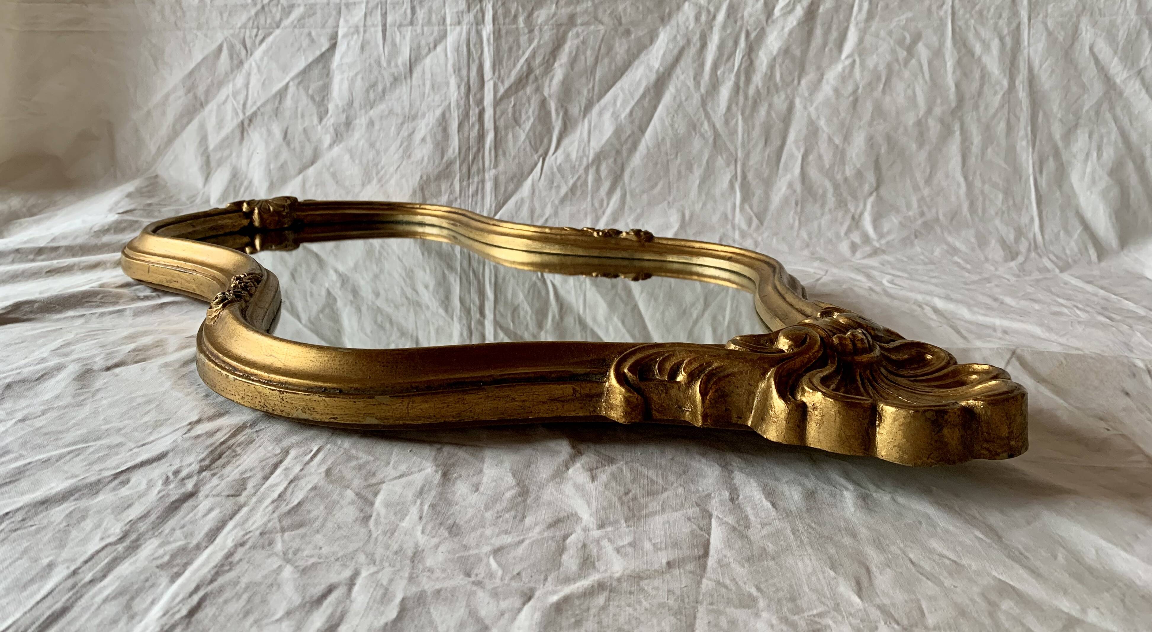 Large rococo mirror in gilded wood