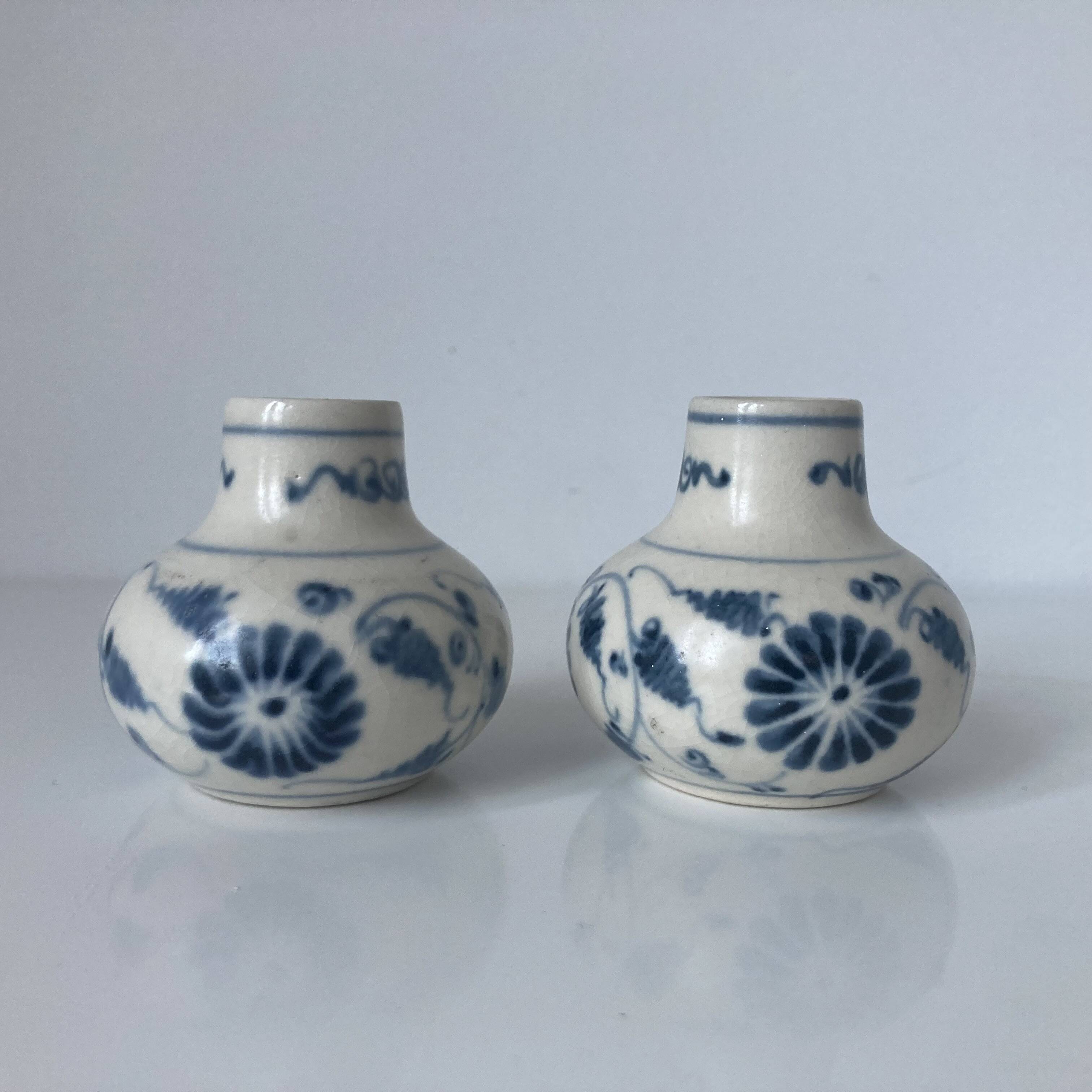 Pair of miniature blue and white Vietnamese ceramic vases with floral decoration.