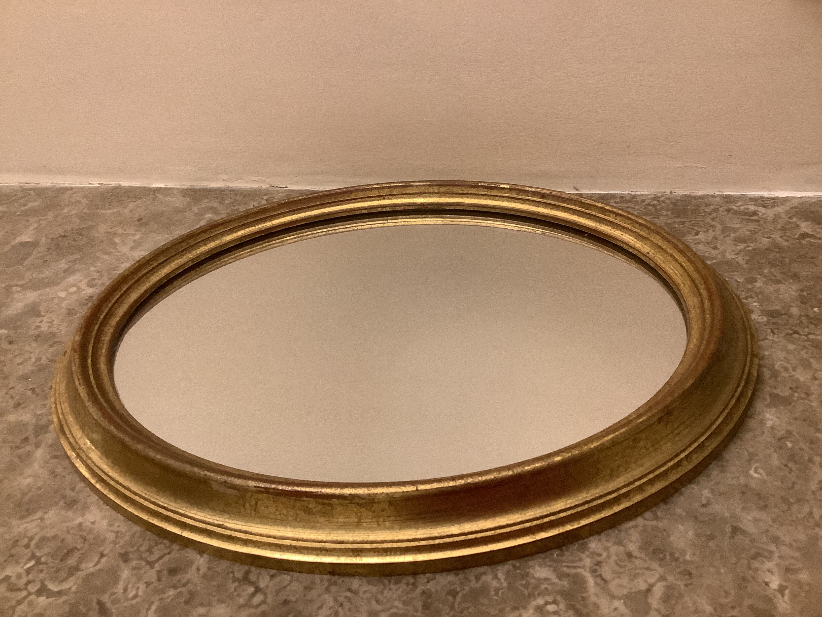 Golden oval mirror
