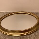 Golden oval mirror