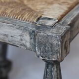 Patinated wooden stool with straw seat