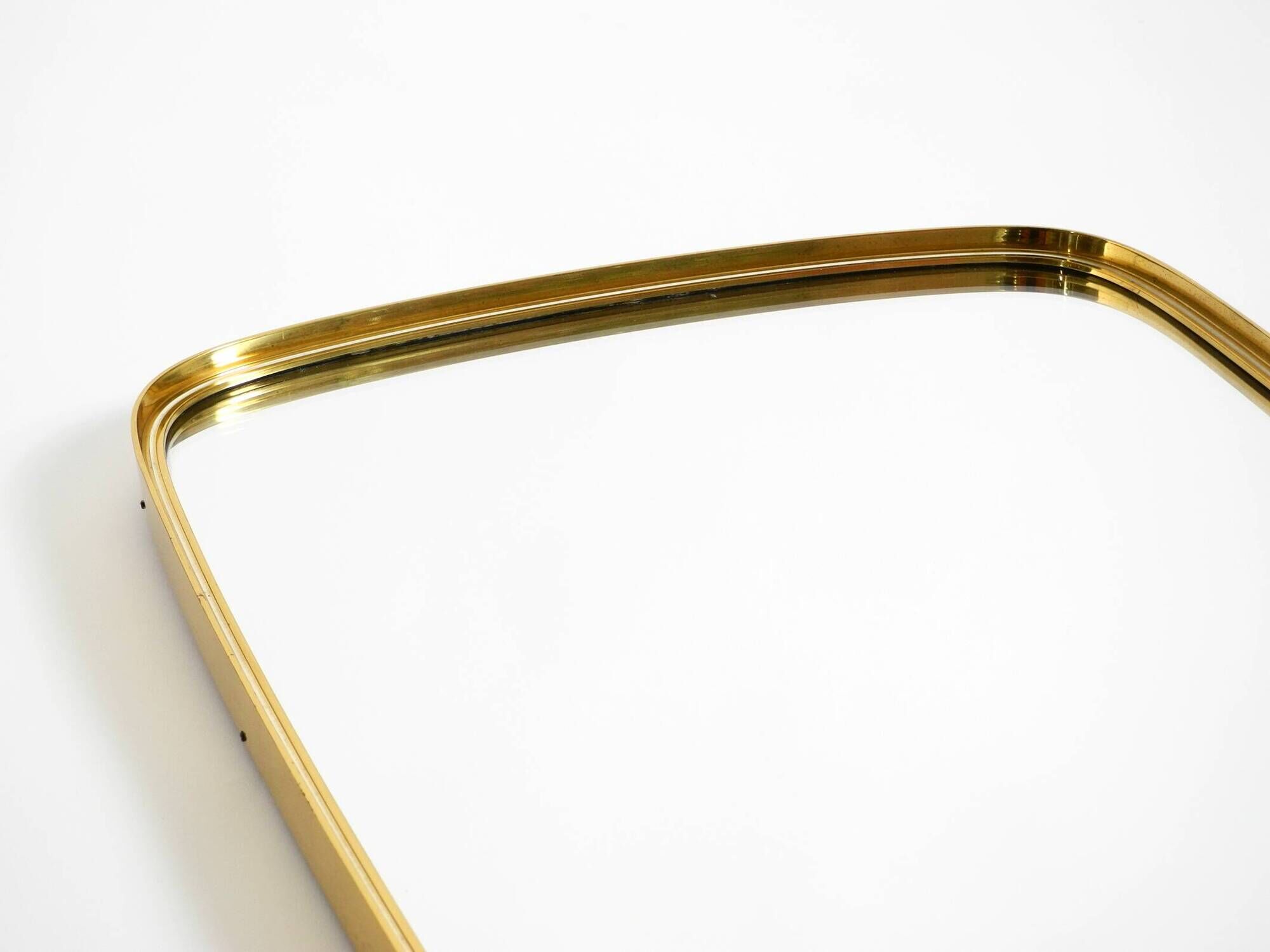 A pair of rare Mid Century "Münchener Zierspiegel" brass wall mirrors