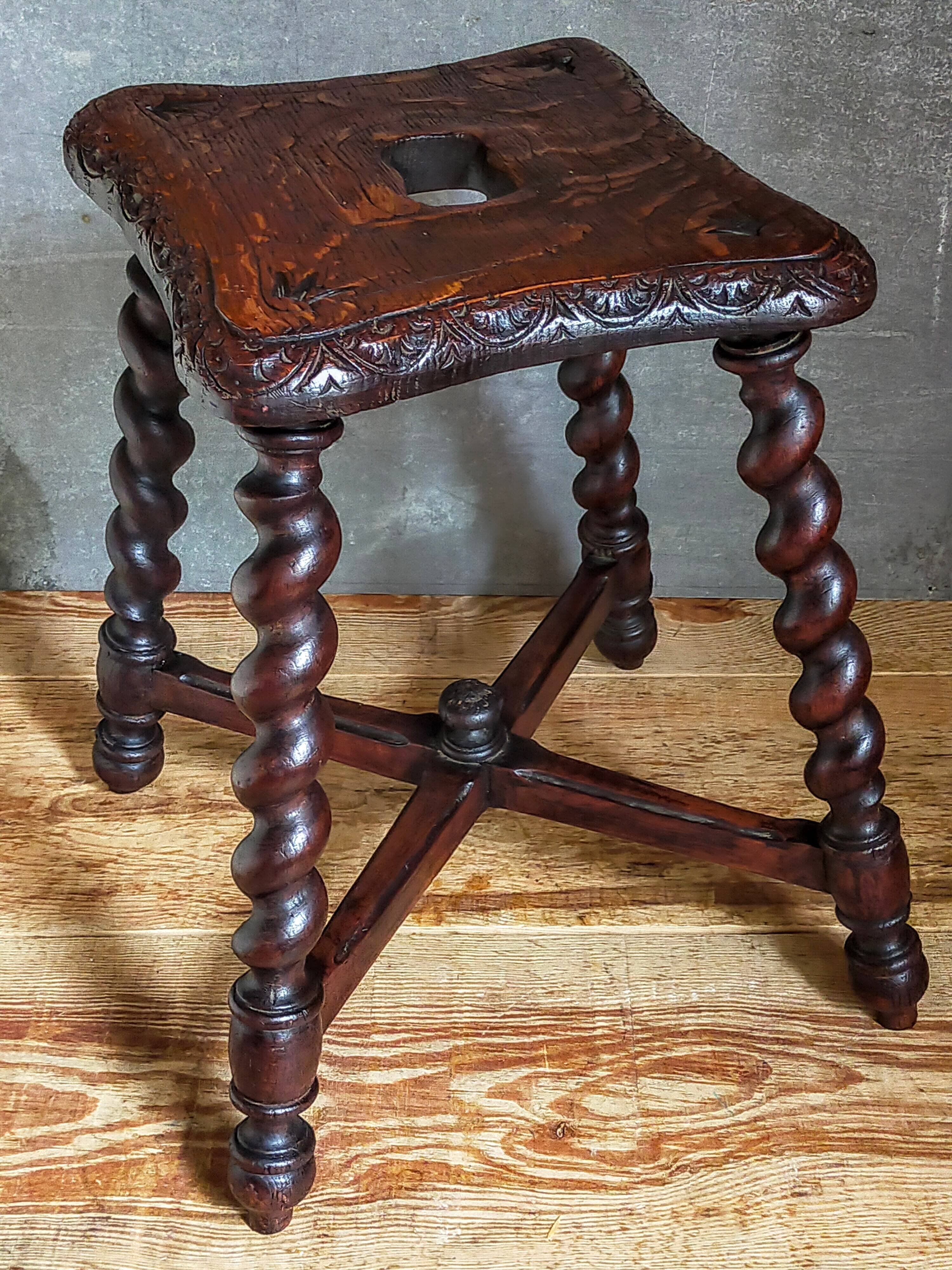 Antique stool in turned and carved solid wood