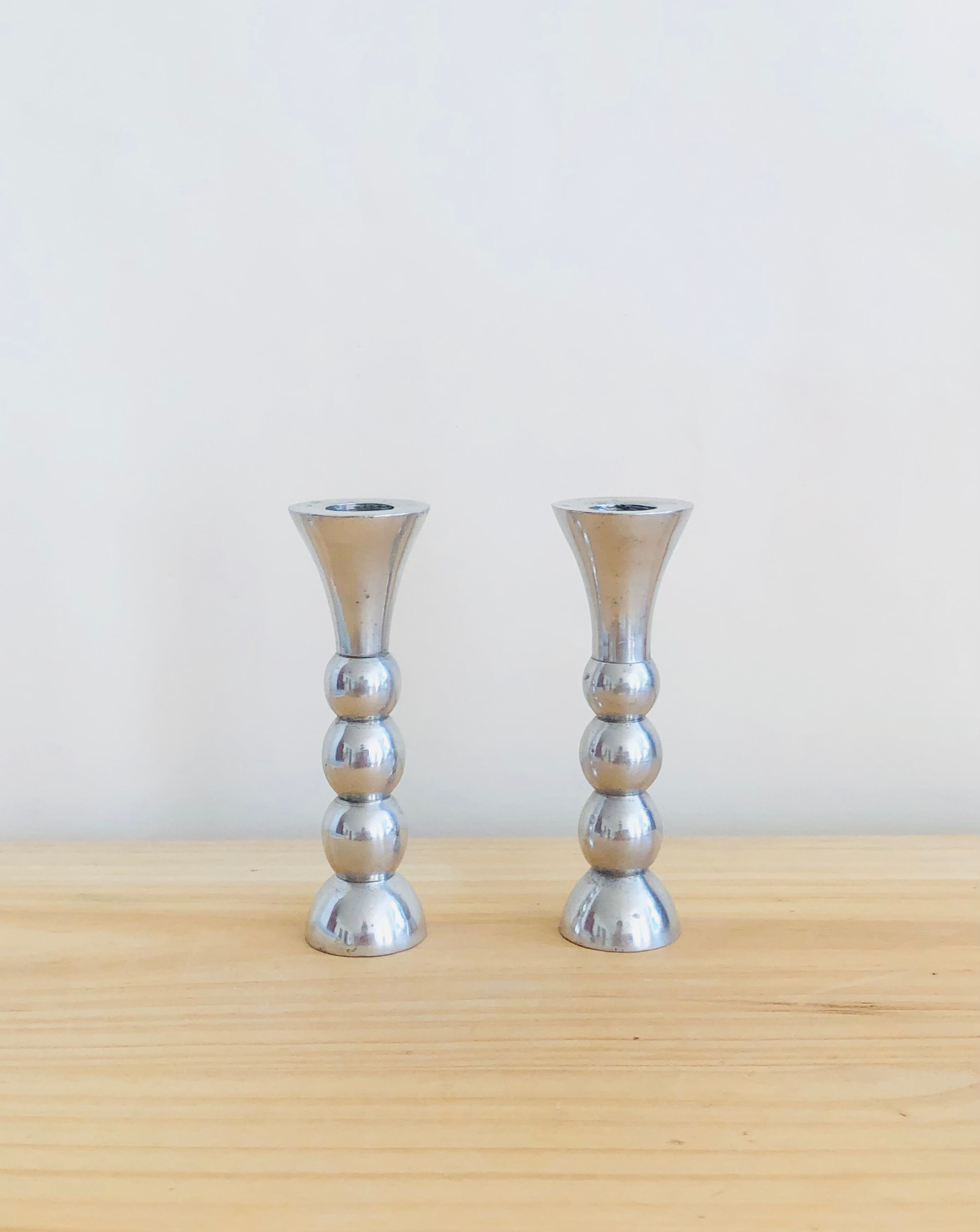 Pair of vintage cast aluminum candle holders