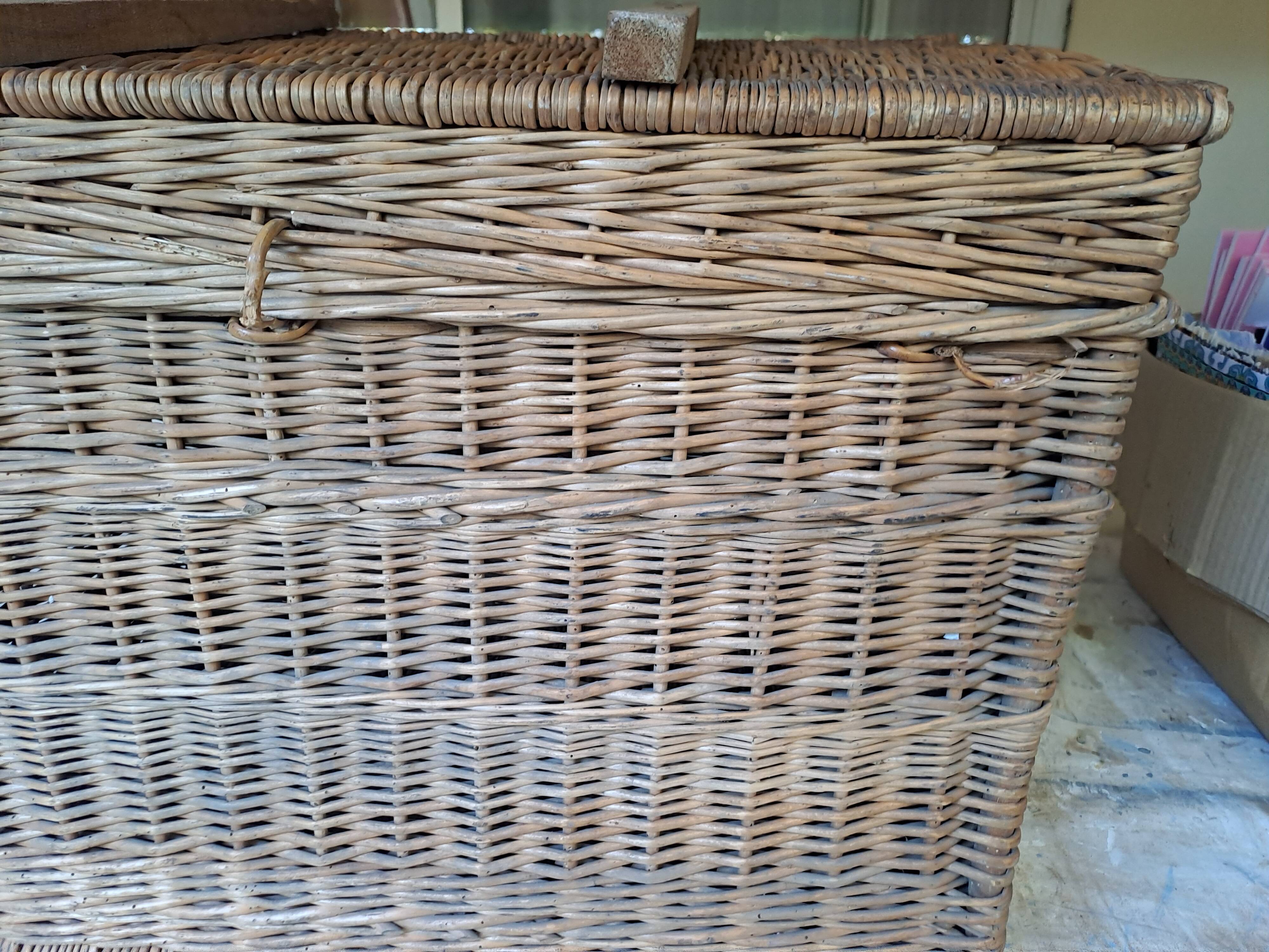 Wicker travel trunk XIX with metal clasps and handles.