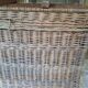 Wicker travel trunk XIX with metal clasps and handles.
