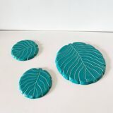 Ceramic trivet and bottle coaster from the 1950s.
