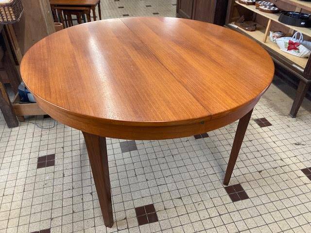 Round wooden table with integrated extensions