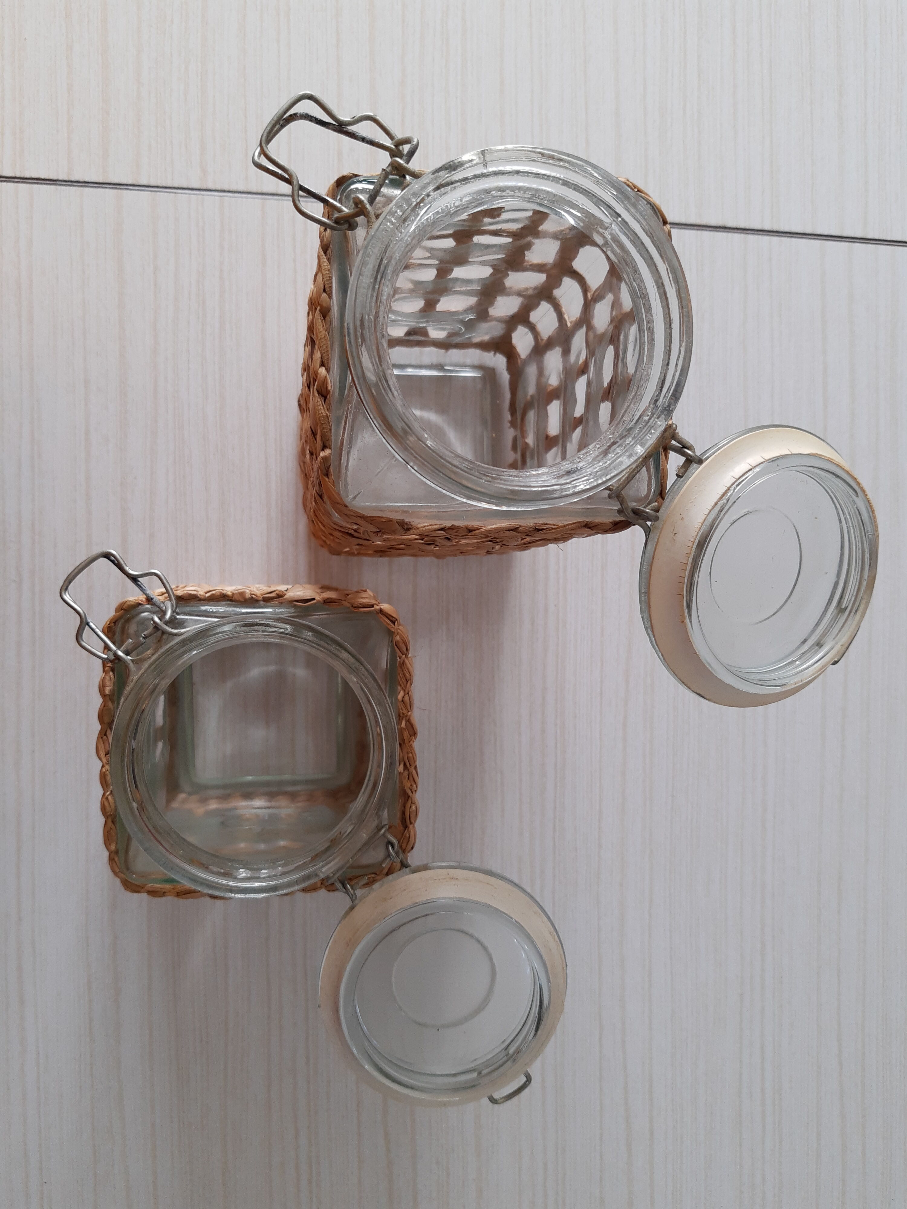 Pair of glass jars and rush