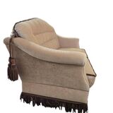 Vintage beige two-seater canapé with fringes.