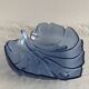 Large leaf-shaped fruit bowl, made of moulded blue glass.
