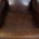 Dark brown sheepskin armchair finished with decorative nails