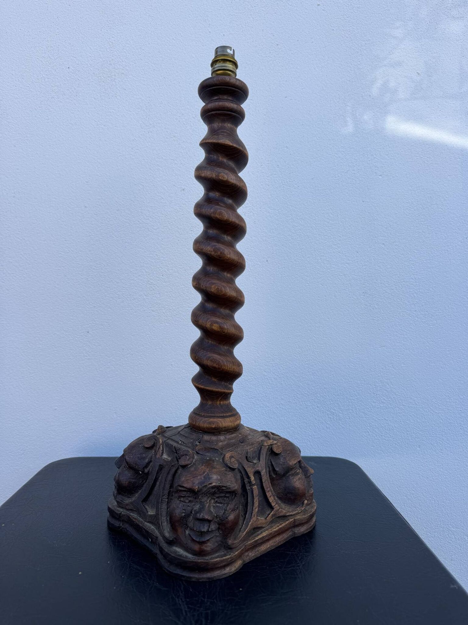 Sculpted wooden lamp with faces, antique.