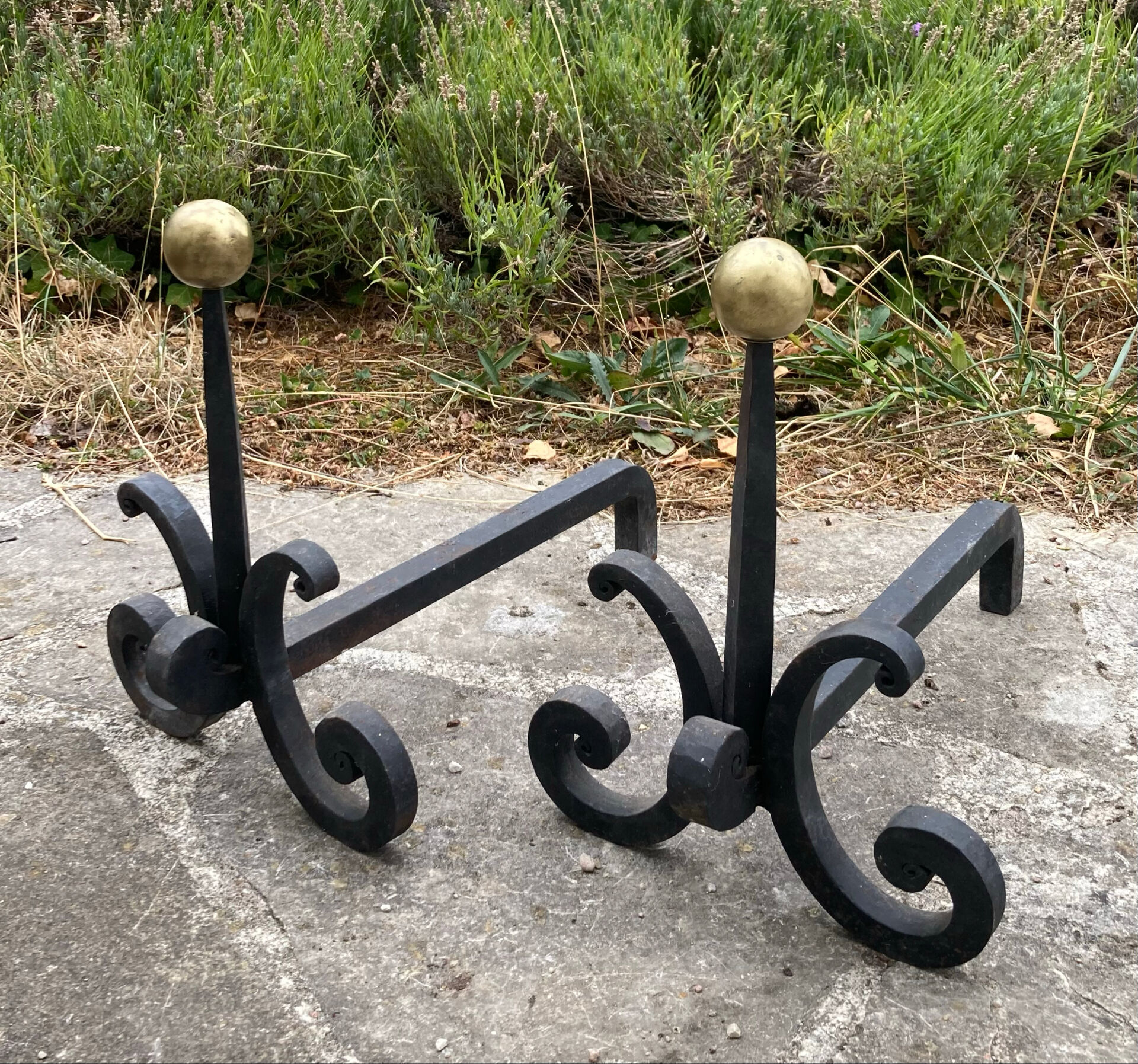 Massive wrought iron chenets from the 19th century topped with brass balls.