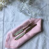 Old brass forks and knives and mother-of-pearl handle