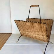Old magazine rack in straw and black metal