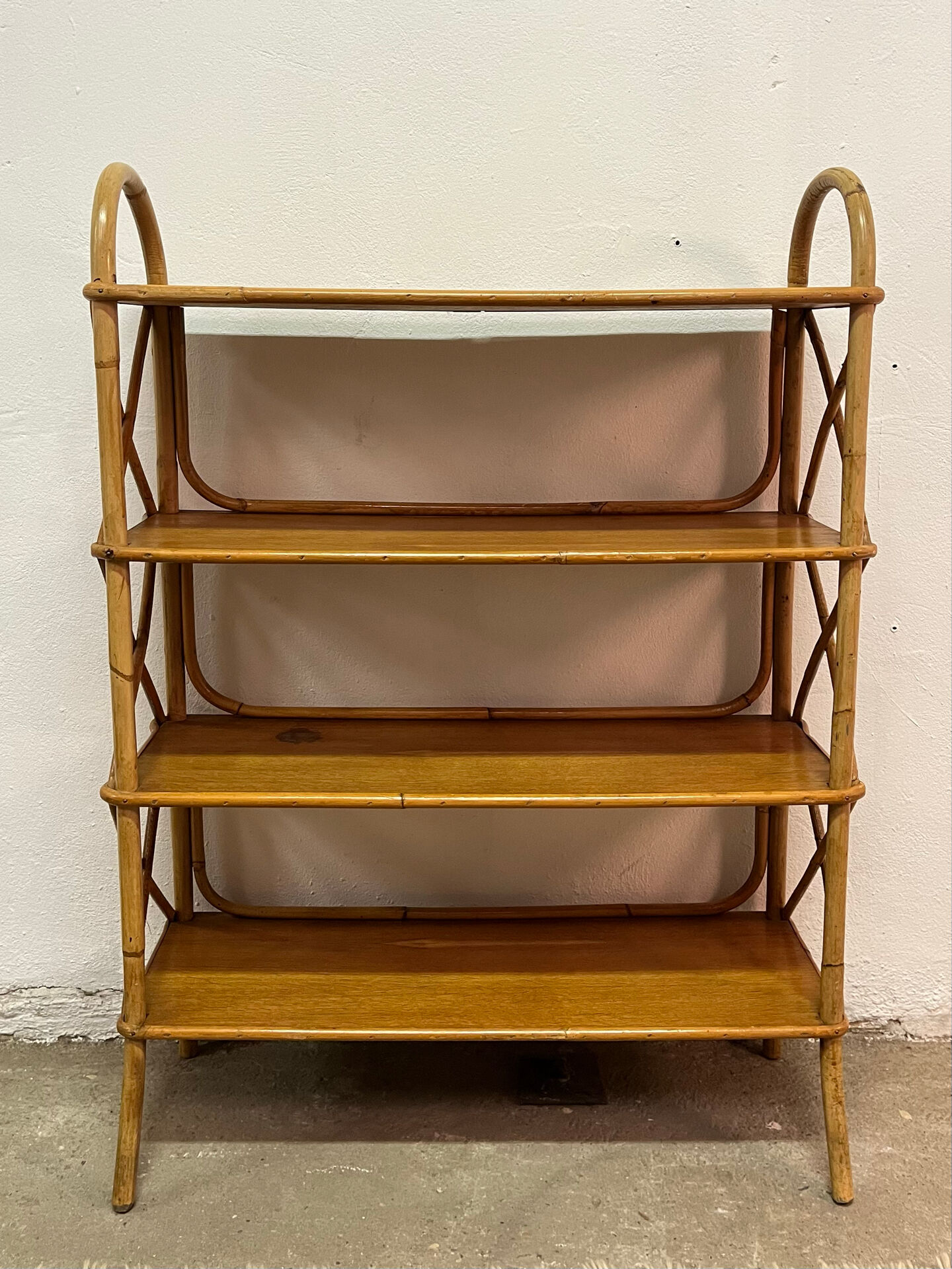 Vintage shelf on legs made of rattan and wood.