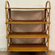 Vintage shelf on legs made of rattan and wood.