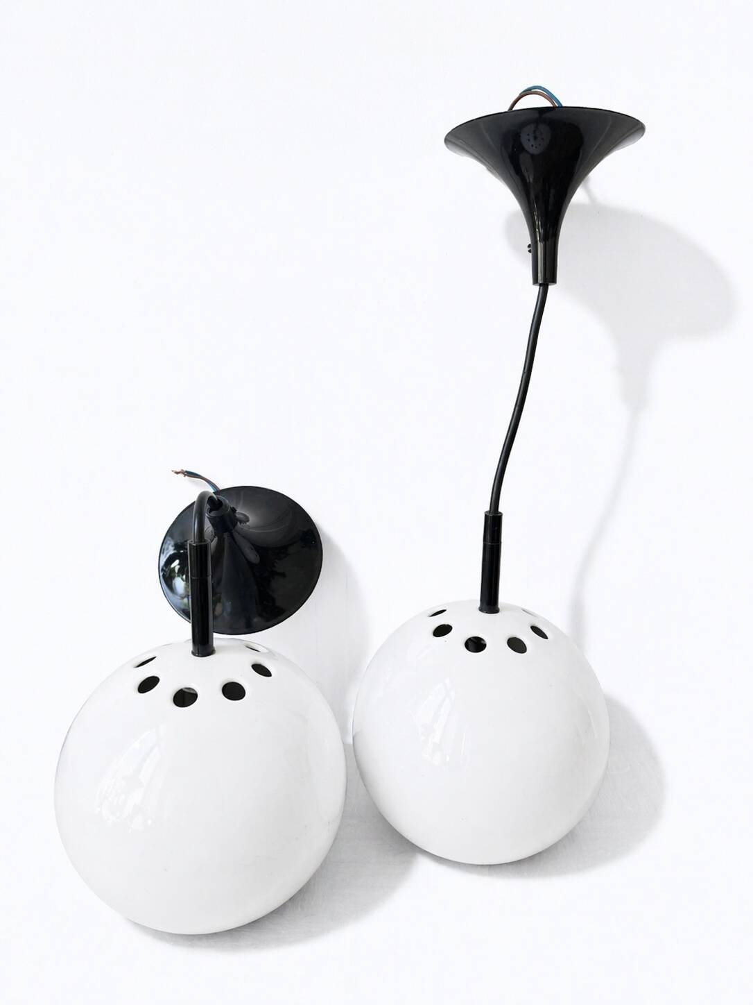 Two white metal globe pendant lights, 1970s.