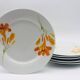 6 “Chriss G. Collection” porcelain dessert plates.
