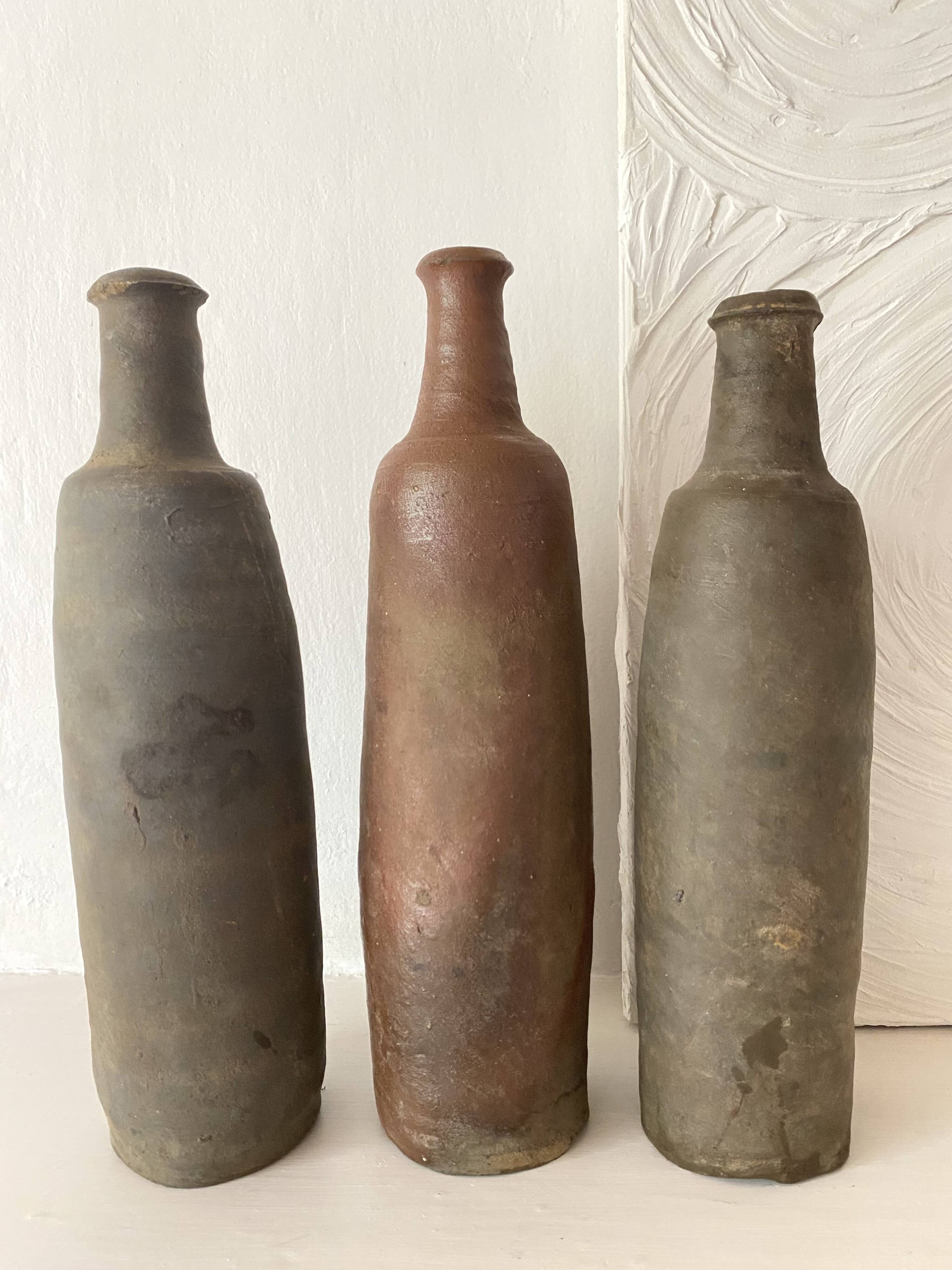 Antique terracotta cider bottles