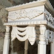 Carved wooden stool with a white patina.