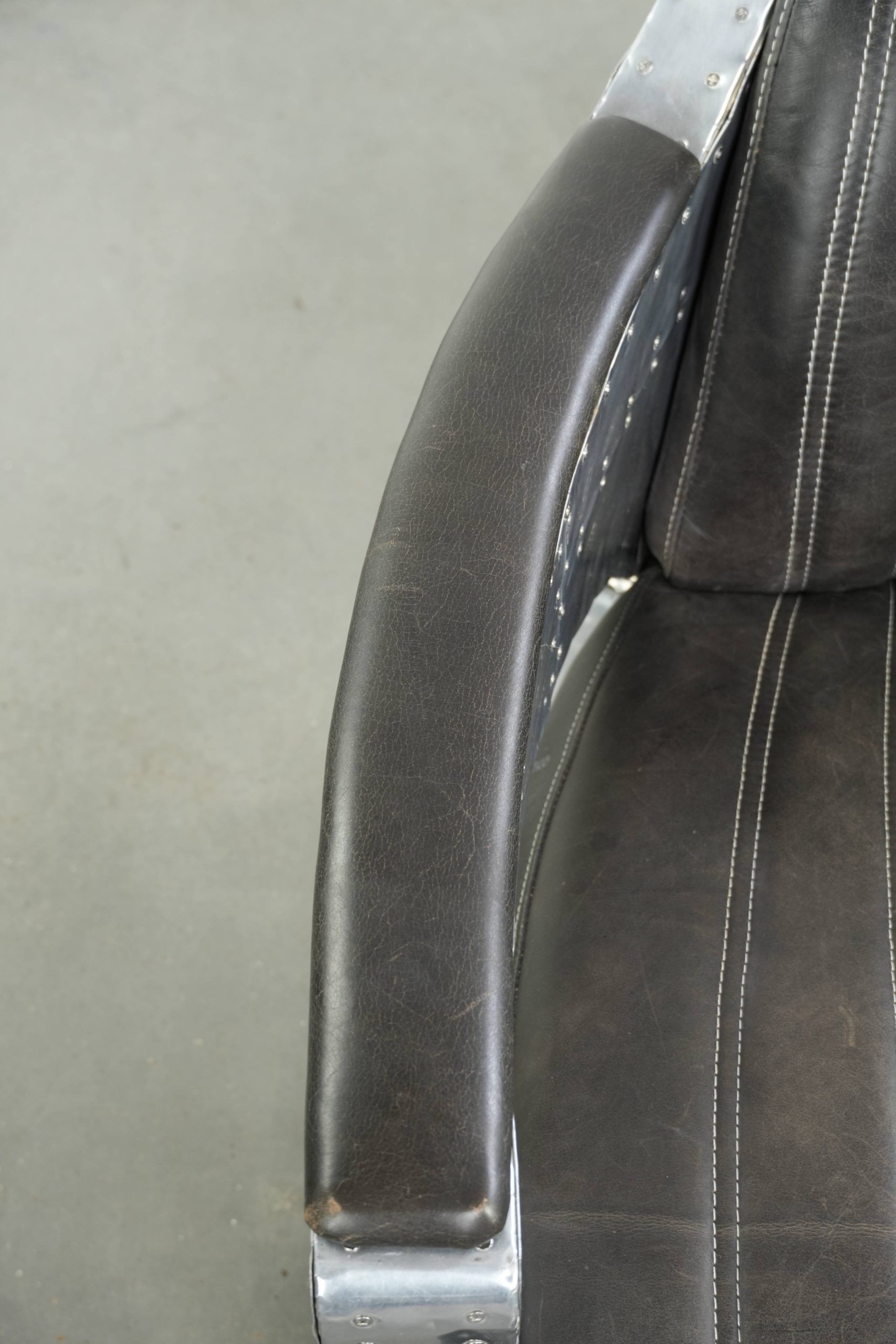 Cow leather aviator design armchair finished with aluminium and rivets