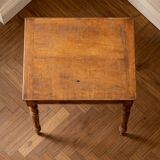 Vintage wooden writing desk with drawer, turned legs, classic style.