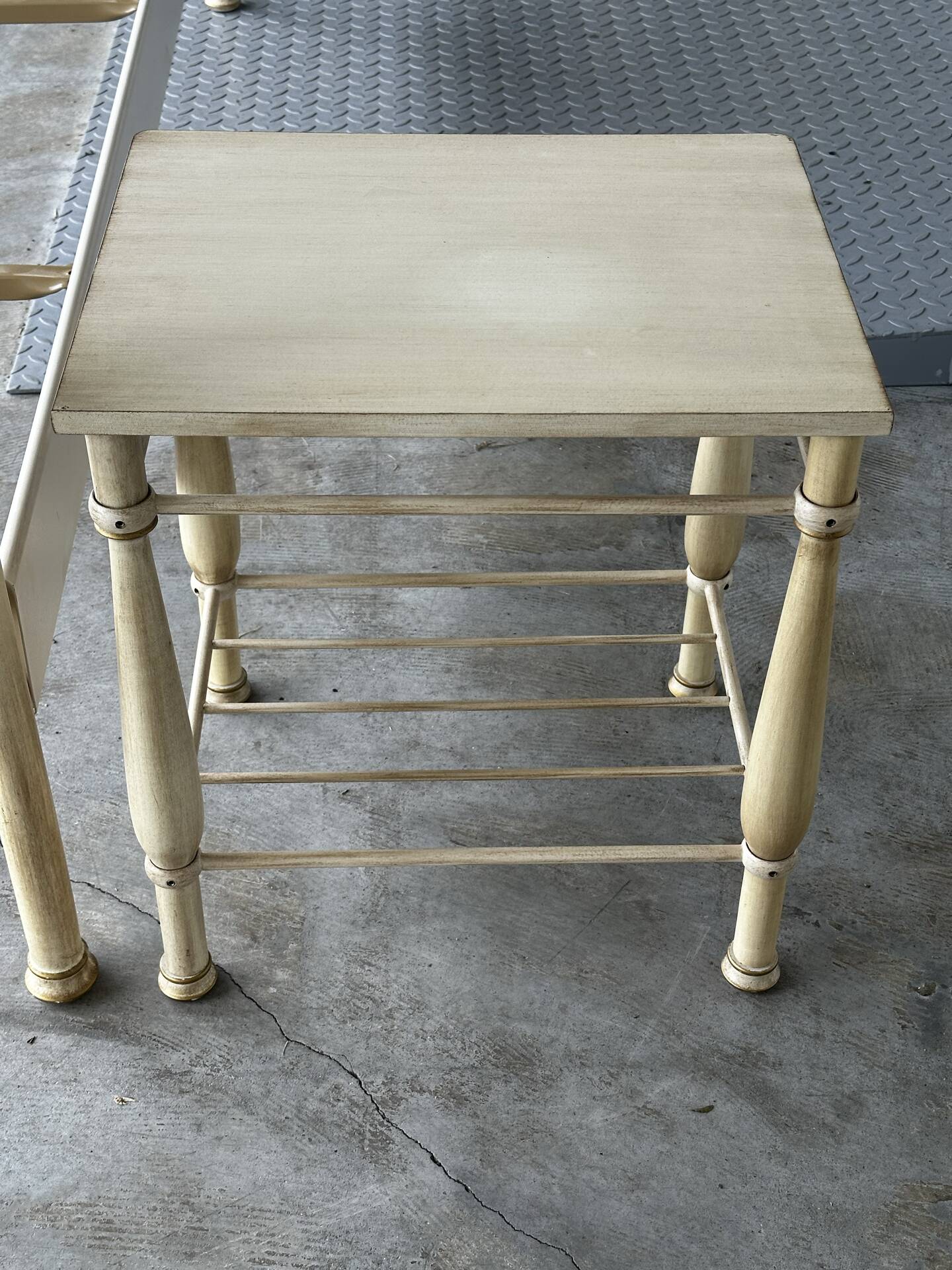 Patinated metal and wood double bed with integrated bedside tables.