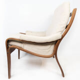 Armchair in rosewood and upholstered with light fabric, of Danish design, 1960s
