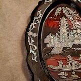 Marquetes lacquer dish with mother-of-pearl inlays figuring 3 characters on a boat in front of a temple.
