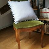 Gray cushion with pompoms