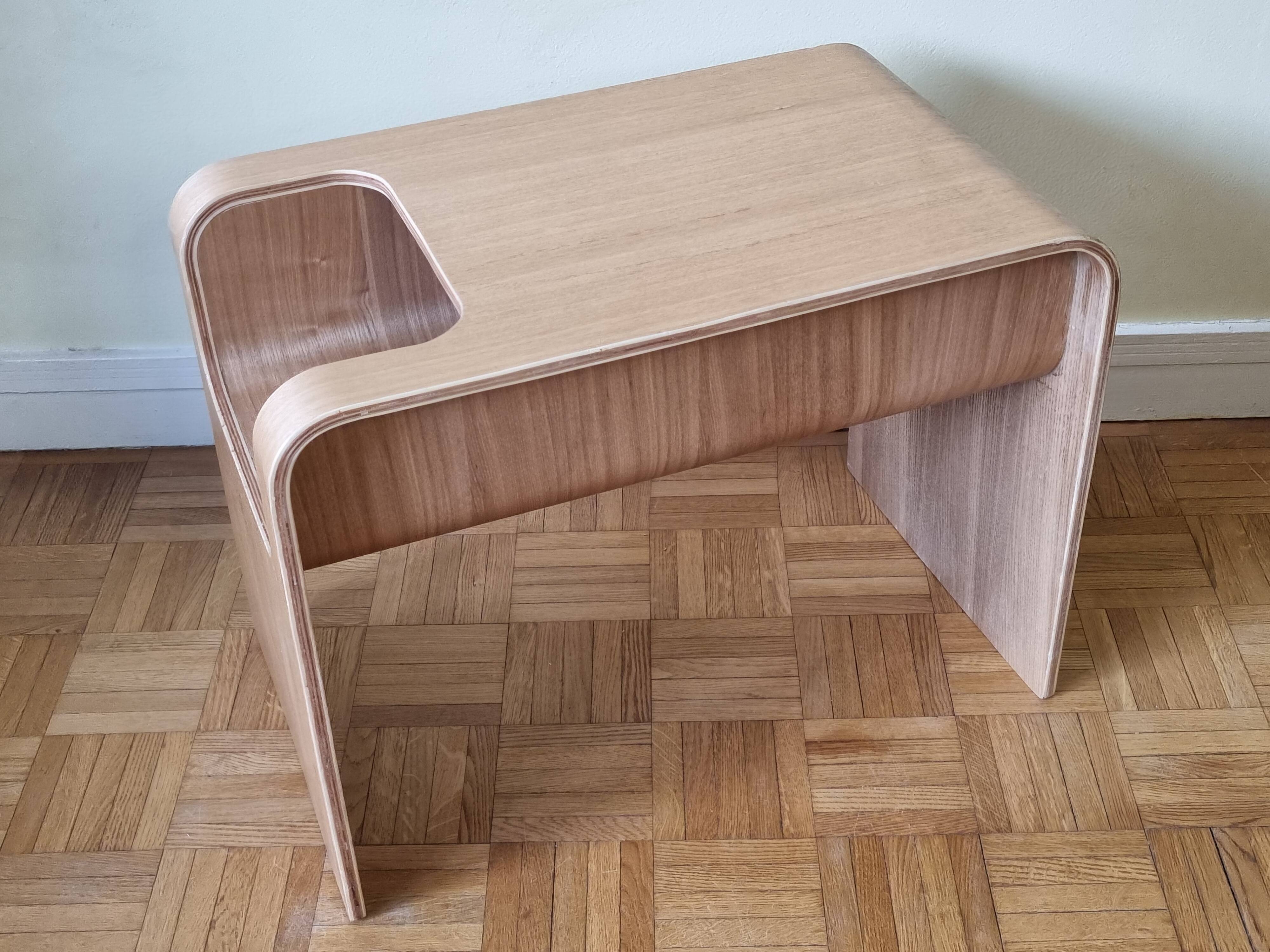 Boone coffee table in curved wood produced by Habitat, design