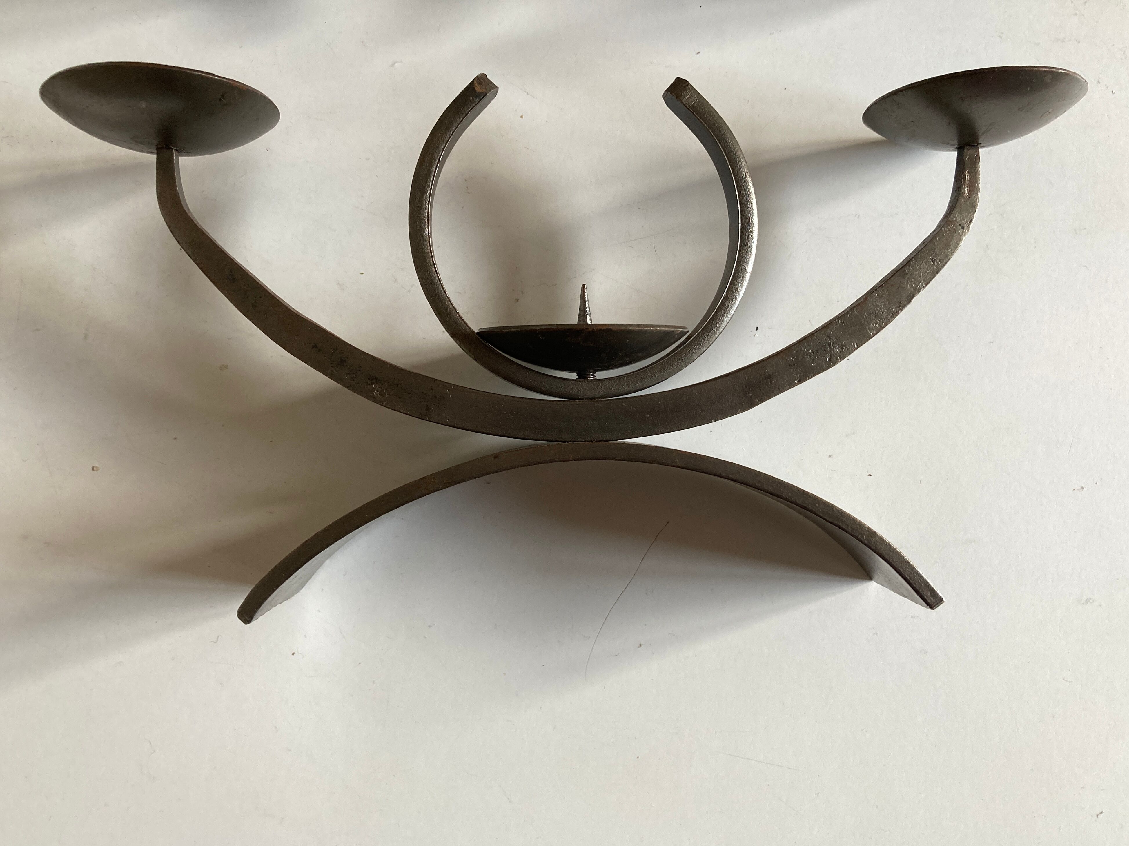 Pair of modernist candlesticks in beaten iron 1970