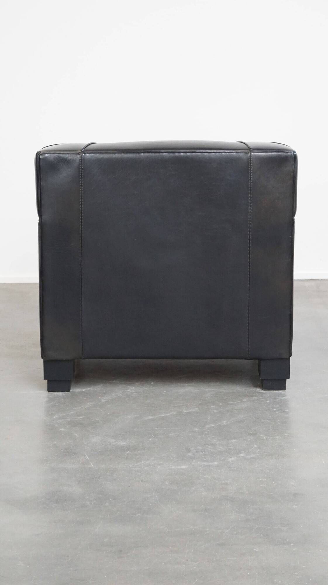 Very comfortable black Art Deco design armchair, made of sheepskin leather