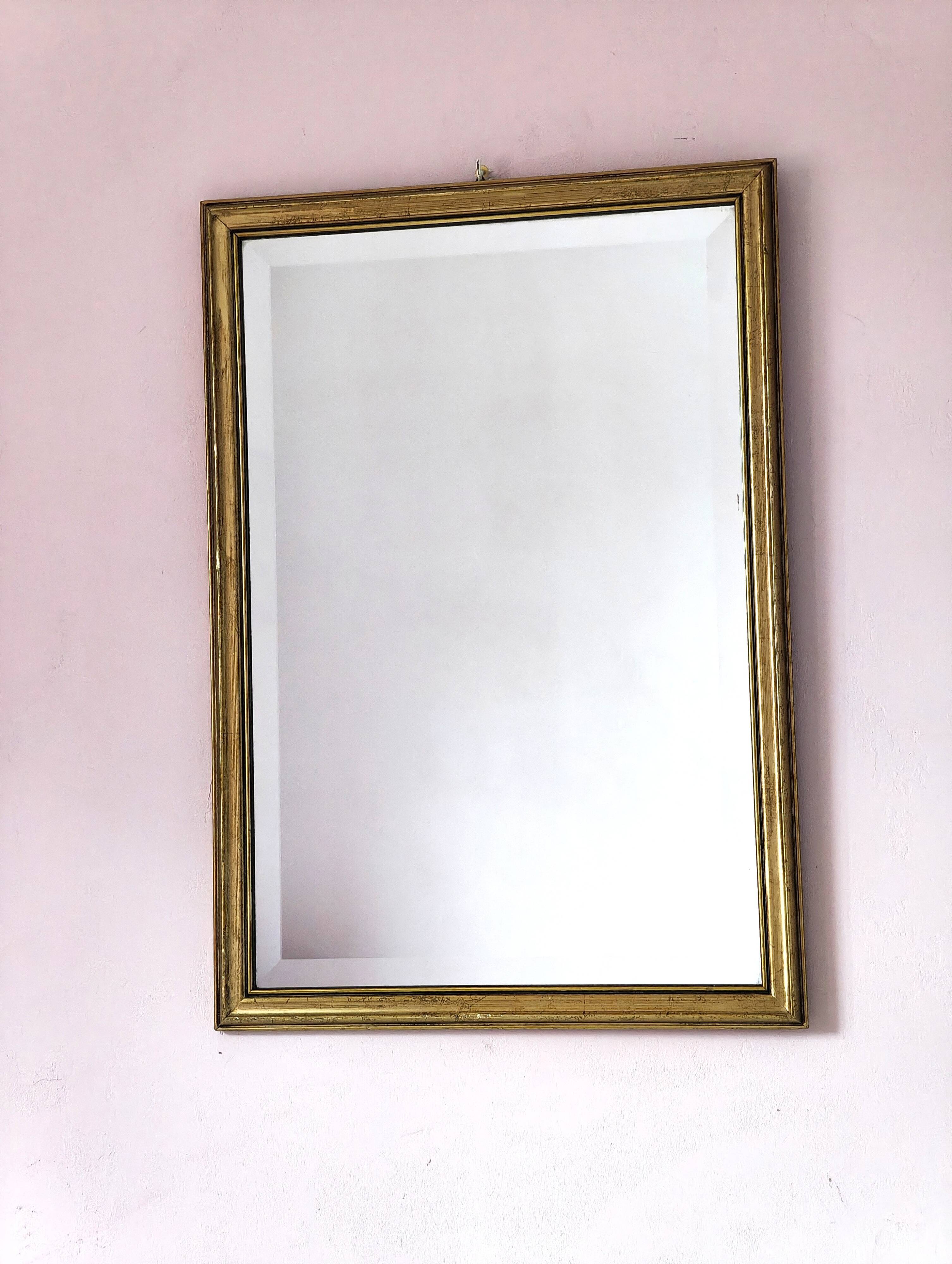 Rectangular gold mirror with bevelled glass.